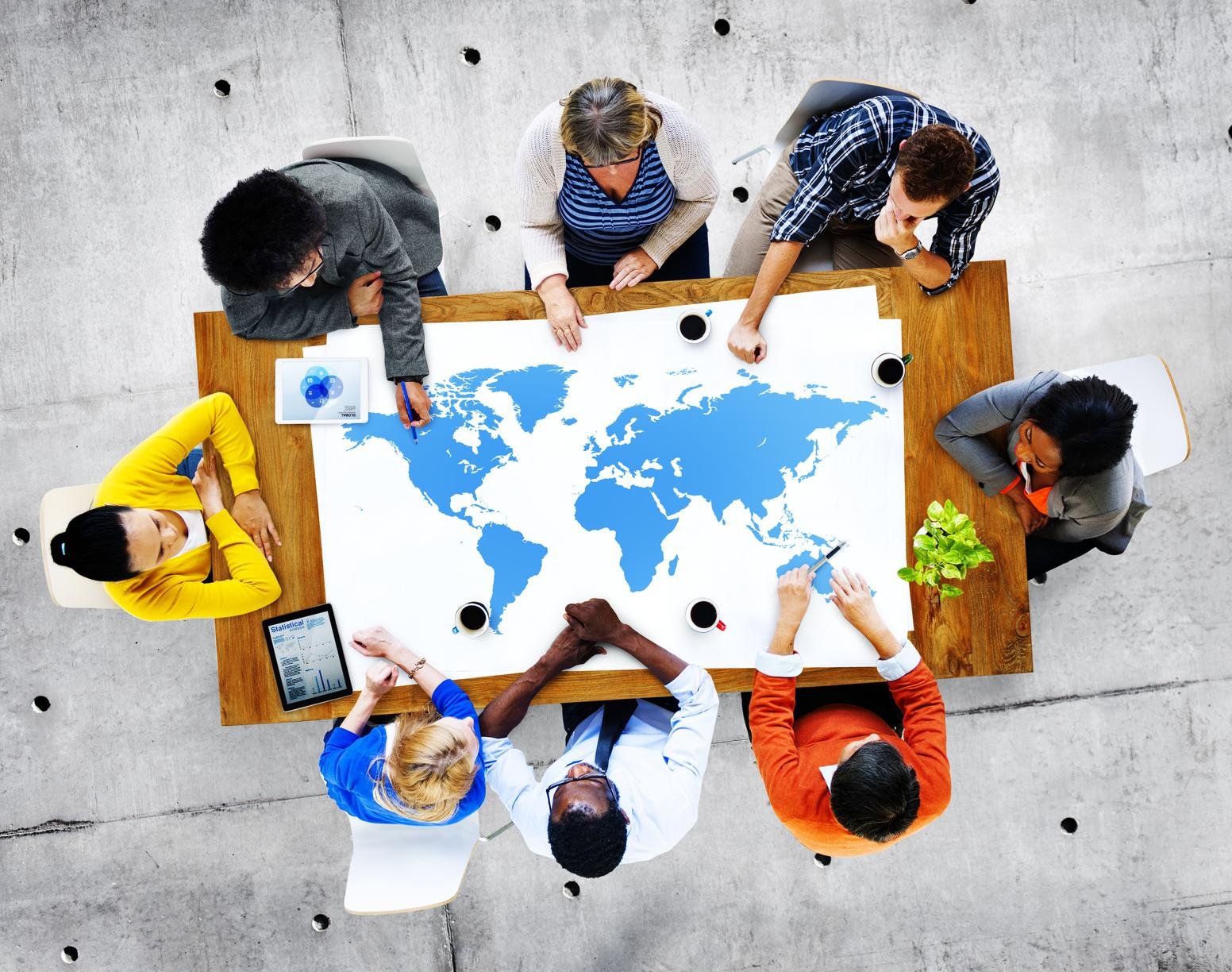 Diverse group of people learning English and engaging in cultural exchange activities in a classroom