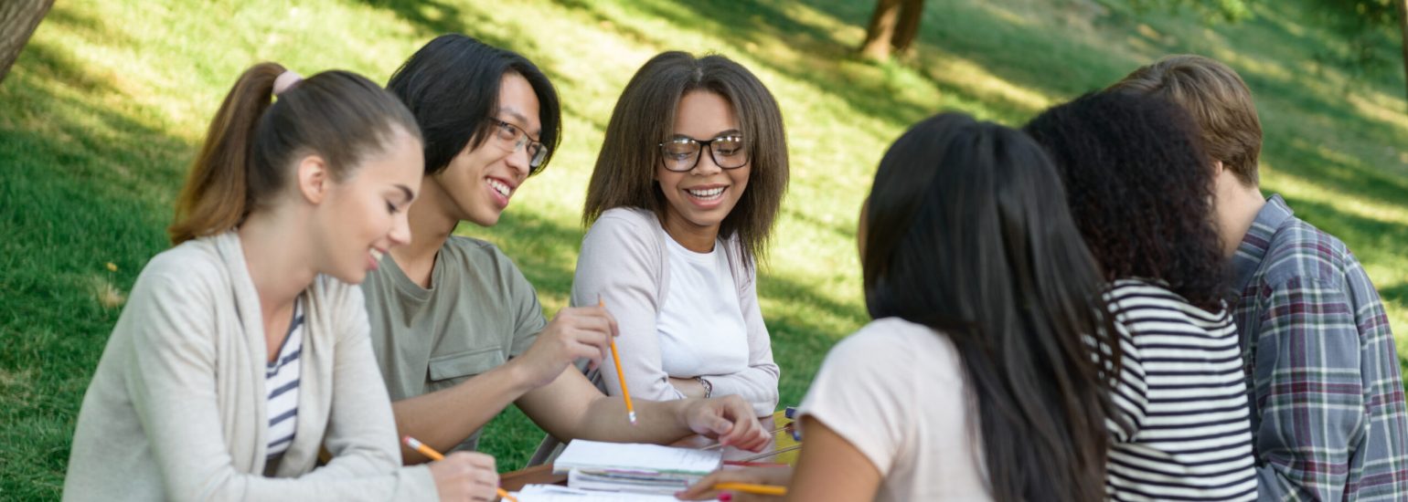 Group of diverse young students studying English outdoors at American English Skills Development Center